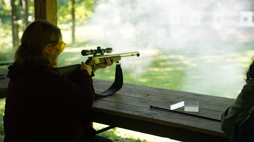 Woman firing a weapon during a practice session