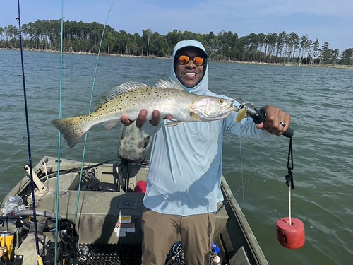 Man on a boat holding a fish