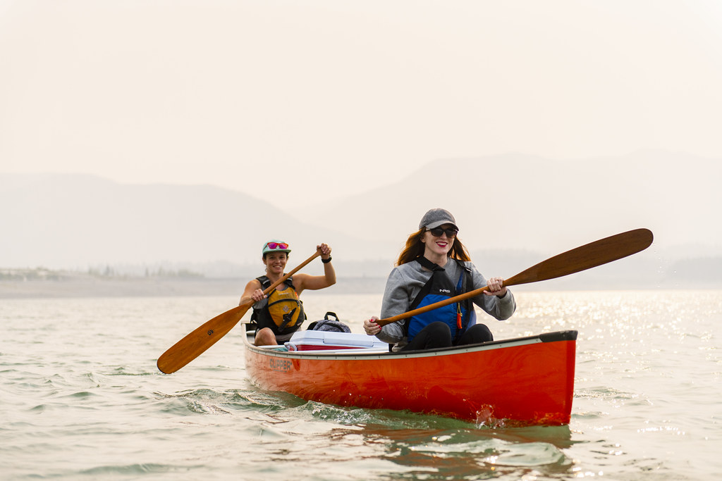 2 women paddling in a red canoe at Barrier Lake