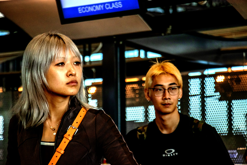 Young Chinese couple with dyed hair at airport on 9-14-26--Milan copy