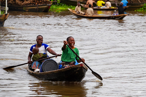 Children paddling through the village