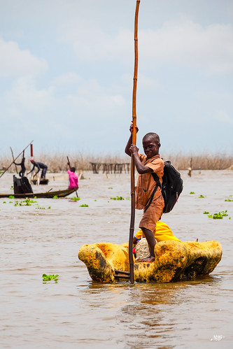 Child in a makeshift boat, Ganvie, Benin