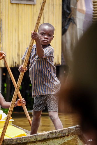 Boy beside a stilt-house doorway, Ganvie, Benin