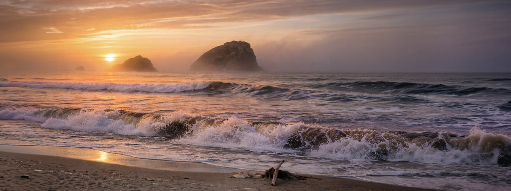 As the Sun Falls Quietly Behind the Sea Stacks and Rolling Waves