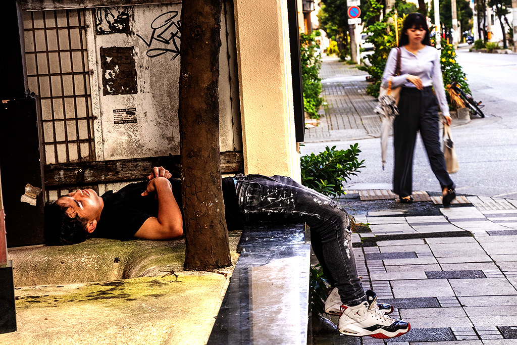 Woman walking by man passed out drunk on 10-2-26--Naha copy