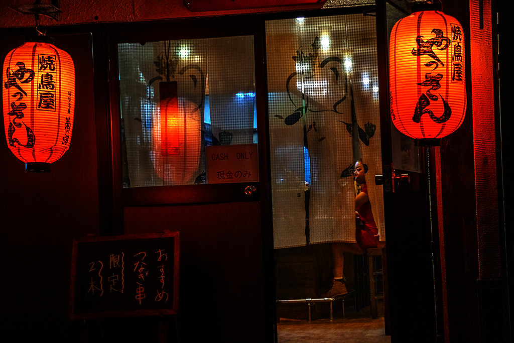 Woman sitting at bar as  barely seen through door on 10-3-26--Naha copy