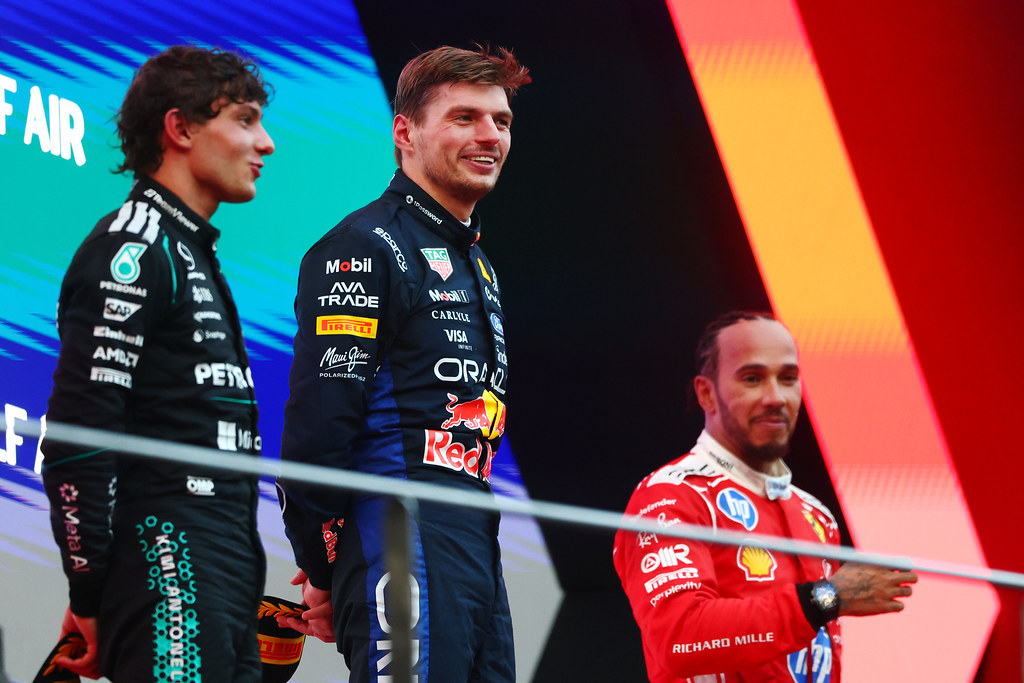 KUALA LUMPUR, MALAYSIA - OCTOBER 04: Race winner Max Verstappen of the Netherlands and Oracle Red Bull Racing Second placed Andrea Kimi Antonelli of Italy and Mercedes AMG Petronas F1 Team and Third placed Lewis Hamilton of Great Britain and Scuderia Ferrari on the podium during the F1 Grand Prix of Bahrain in Malaysia at Sepang Circuit on October 04, 2026 in Kuala Lumpur, Malaysia. (Photo by Clive Mason/Getty Images) // Getty Images / Red Bull Content Pool // SI202610040362 // Usage for editorial use only //