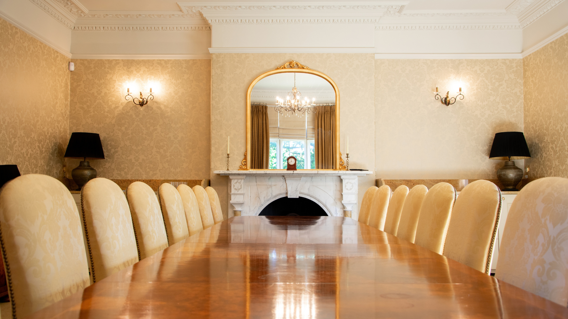 A long table with high backed chairs.