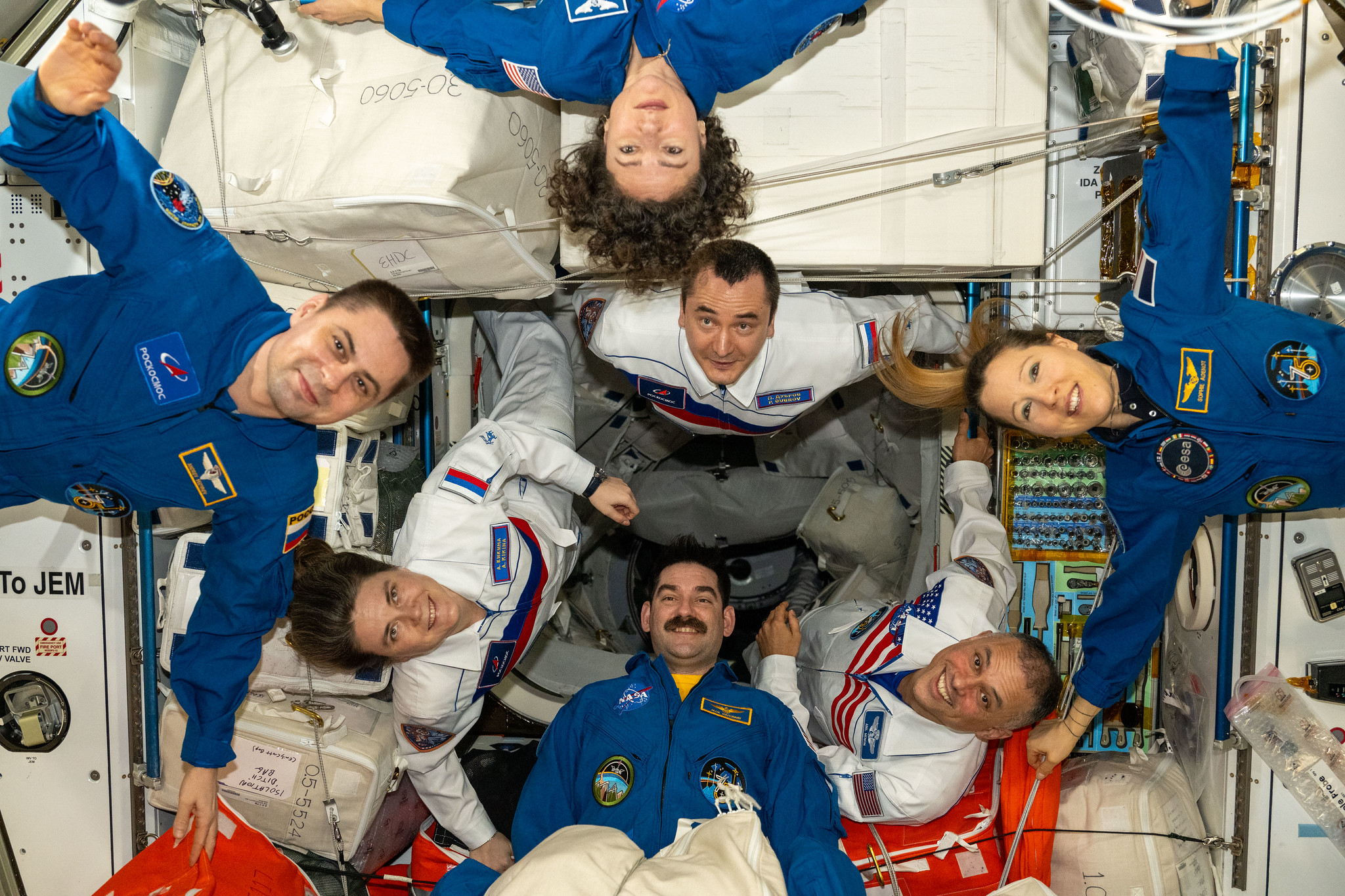 Seven of the Expedition 75 crew members take a team portrait