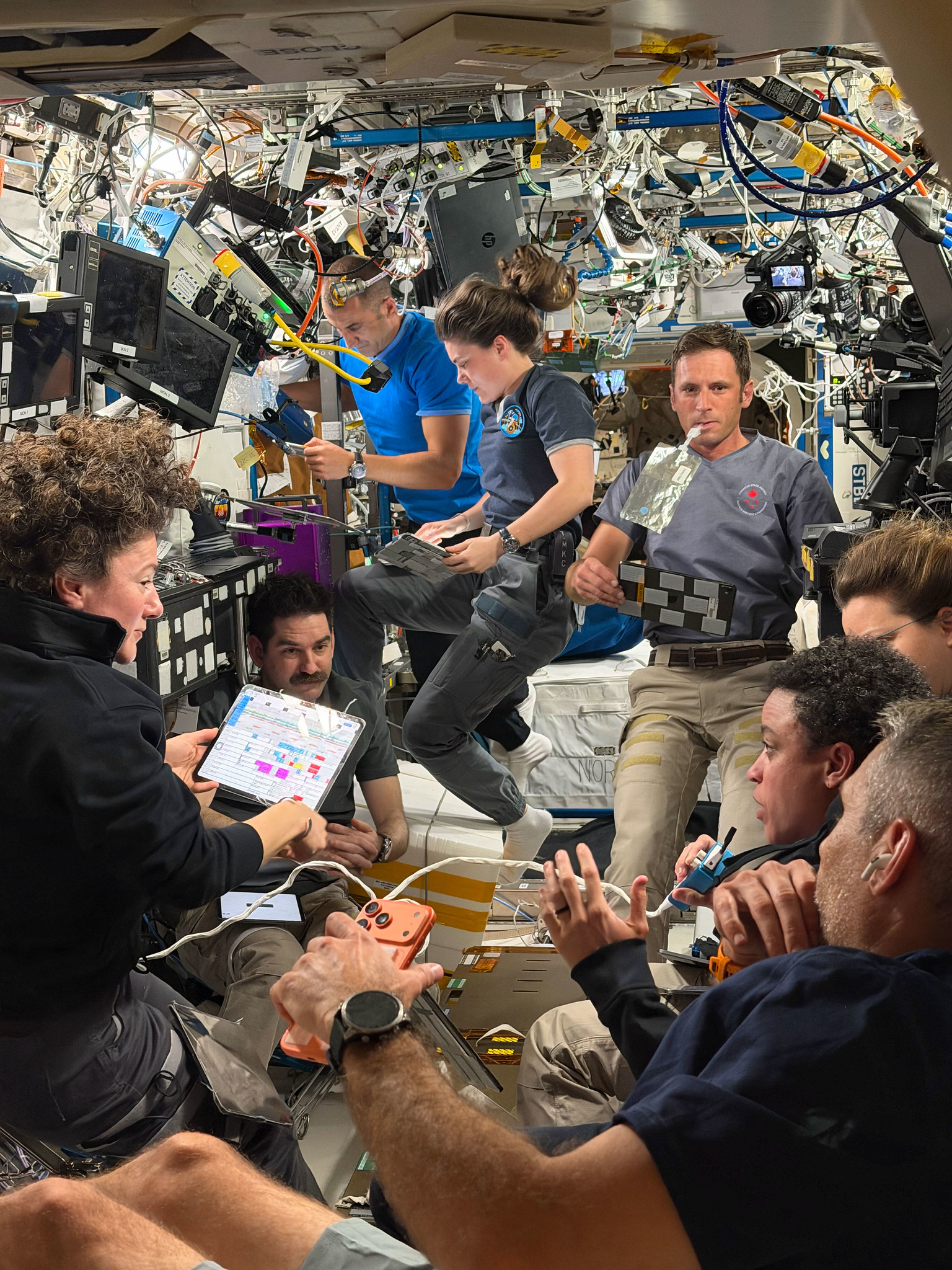 Expedition 75 crew members gather for a daily planning conference