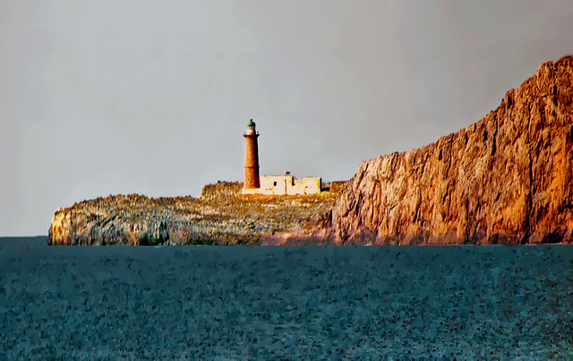 Greece, Antikythira island, cape Apolytares lighthouse, full zoom-in from quite a distance aboard the ferry