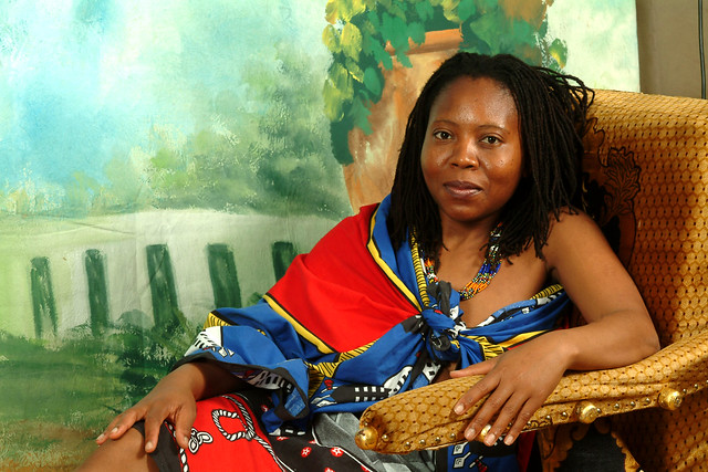 DSCF5855 Gabisile South African Model in King Mswati III Swazi Ethnic Cultural Cloth Wrap With Zulu Bead Necklace on African Chaise Longue Portrait Photoshoot Shoreditch Studio London