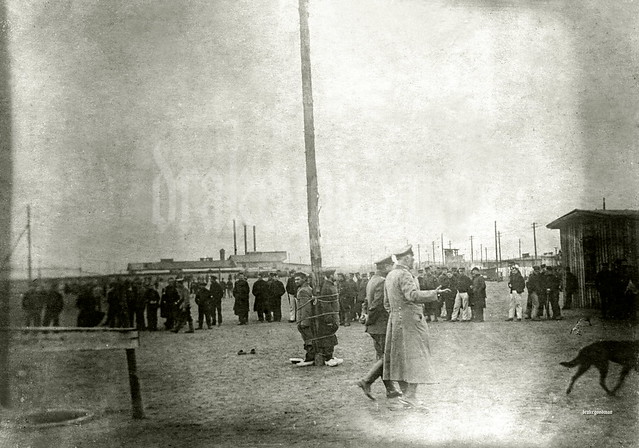 Clog wearing Belgian prisoners of war tied to a pole as punishment, Kriegsgefangenenlager Hameln 1917