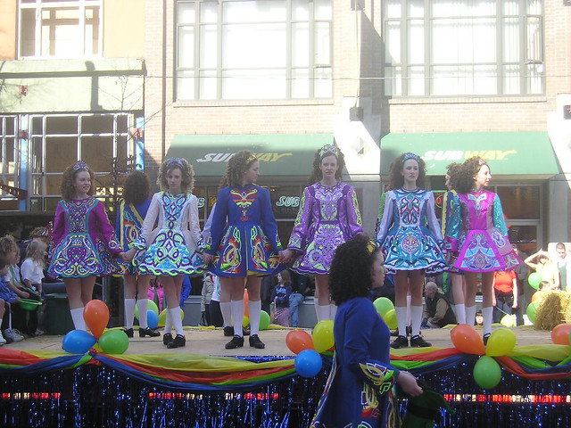 Irish dancers holding hands on a float at the Vancouver St. Patrick's Day Parade