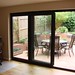 Created sun room out of half of double garage with bi-fold door.