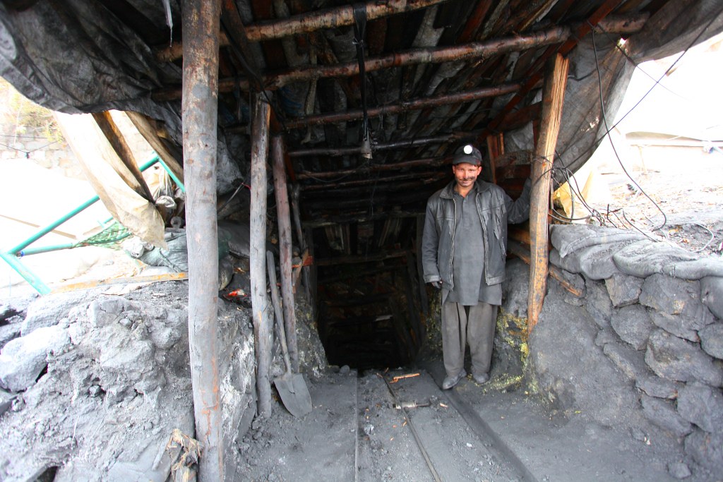Coal miner standing in this adit, near Muzaffarabad, AJK, Kashmir