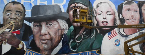 Wide wall mural featuring famous portrait faces