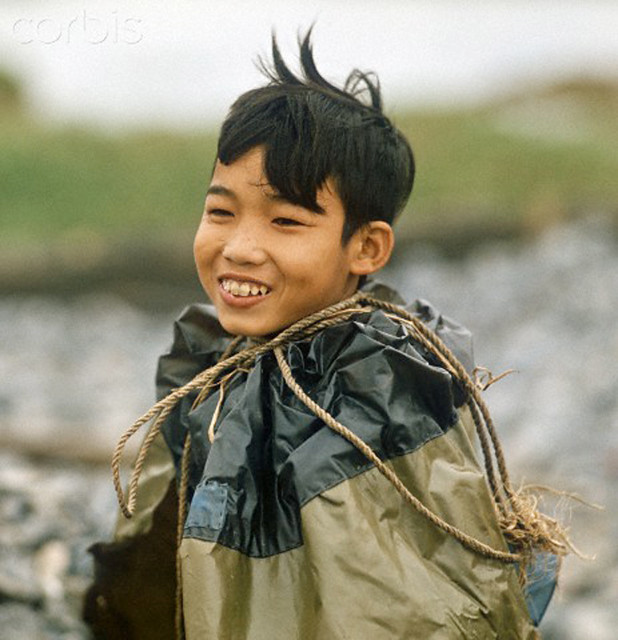 Hanoi 1973 - A Vietnamese boy with a rain coat Photo: Wern. 