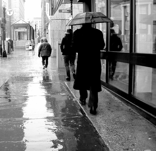 boston downtown crossing man with umbrella black white