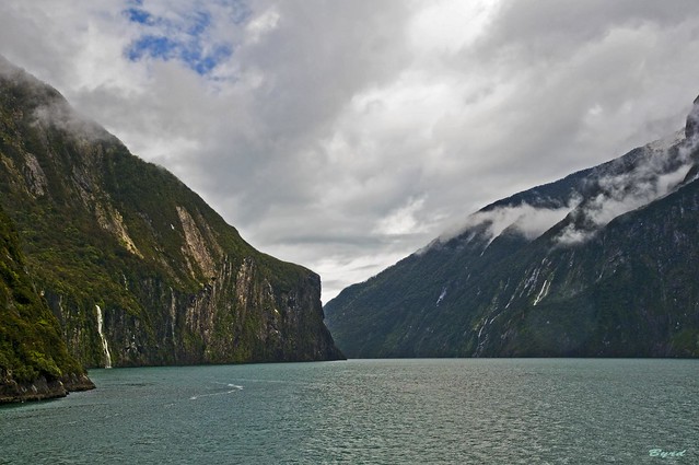 Spots of sunlight on the cliffs of Milford Sound, Fiordland, South Island, New Zealand