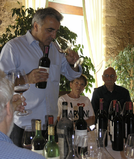 Giusto Occhipinti is describing the wines we're about to try at his wine tasting at COS Azienda Agricola while Judy and Marvino Zeidler listen.