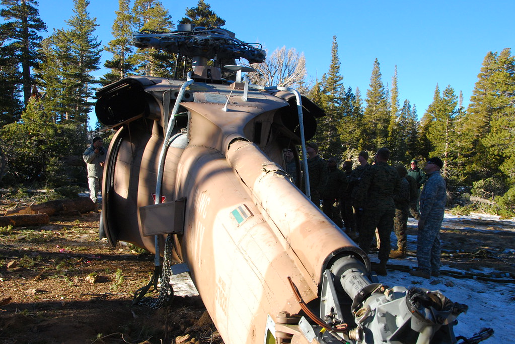 California Army National Guard Chinook crew works with multi-service recovery team to slingload a downed Navy helicopter from high mountain training area