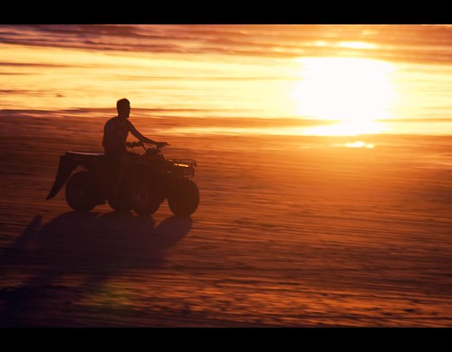 ocean sunset shadow sea newzealand sun beach wet bike silhouette digital speed canon sand shadows shoreline fast 4wd quad motorbike shore nz dslr aotearoa speeding fourwheeldrive settingsun eos400d