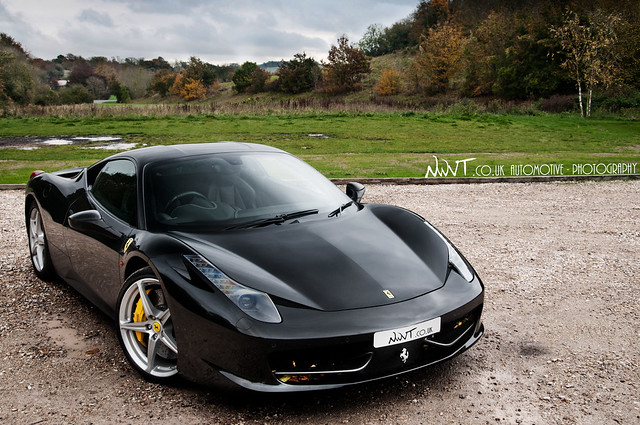 Black Ferrari 458 Italia Cooling Down After A Wet And Dirty Drive.