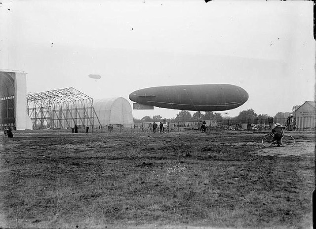 Farnborough - The army airship Gamma II on the ground in front of the airship sheds. In the distance another airship can be seen in the air.