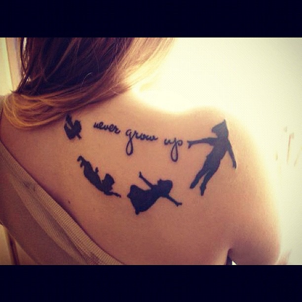 Minimalistic style Peter Pan tattoo located on the