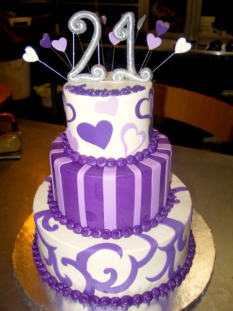 3-tier Wicked Chocolate cake iced in white & purple butter icing decorated with fondant moulin rouge twirls, stripes, hearts & 3D silver twirly #21