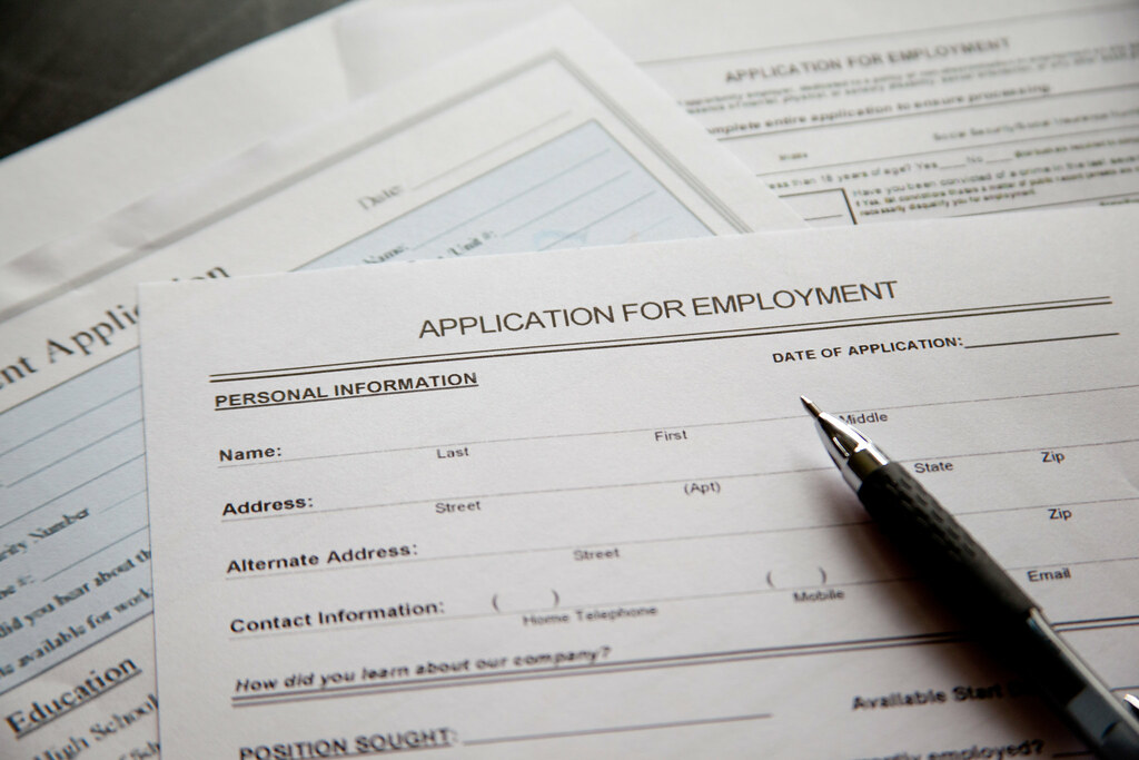 Picture of a job application and a pen - Job Resources for Undocumented and DACA-Protected Youth