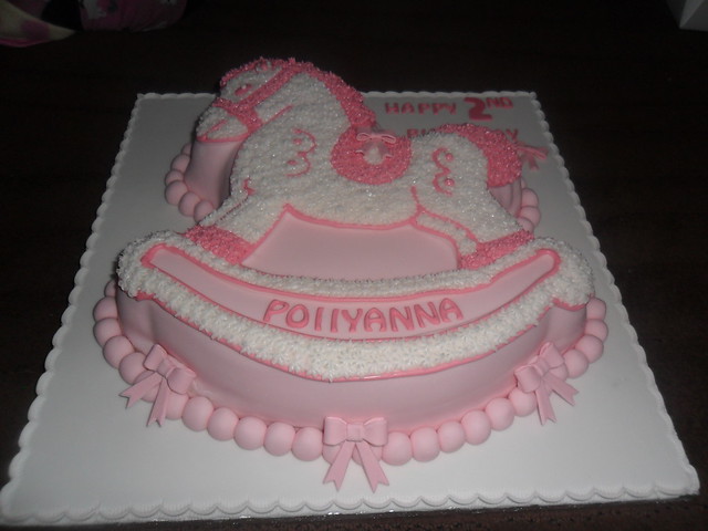 pink white rocking horse birthday cake