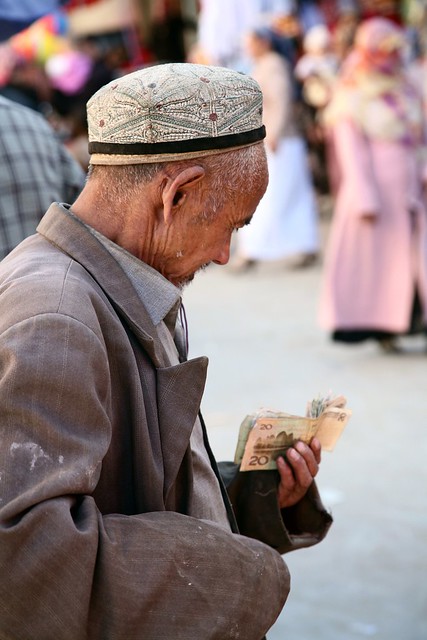 Elderly Uyghur Man Examining Money Hotan Xinjiang Far West China