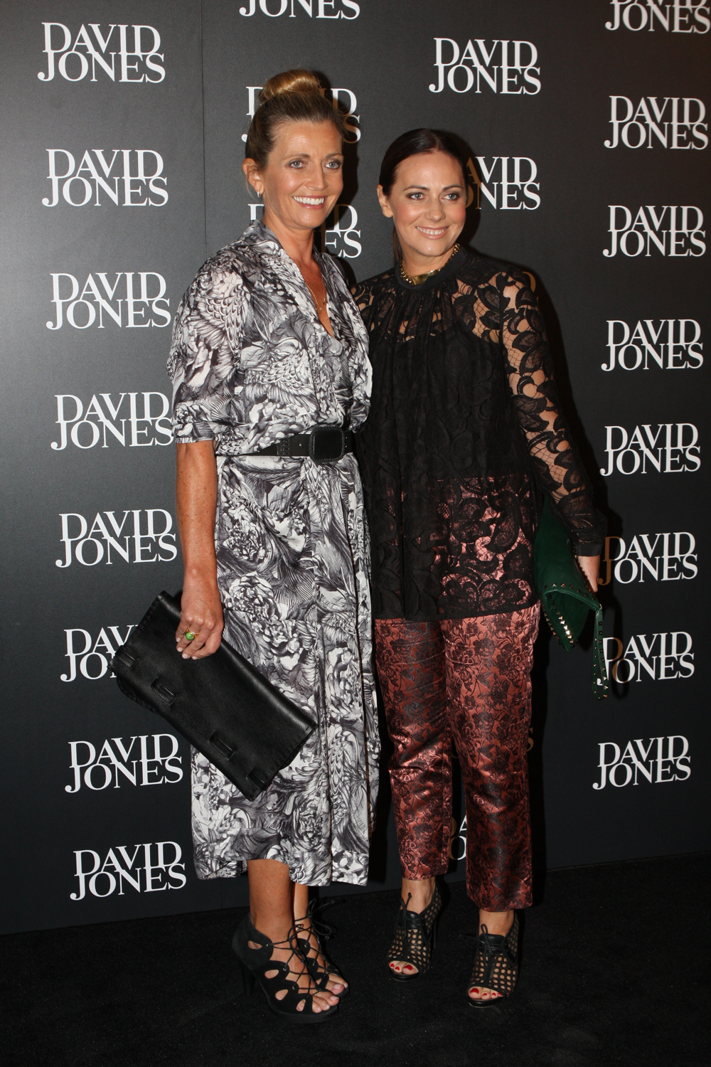 Simone and Nicky Zimmermann in a patterned outfit and black lace respectively at a Sydney event in 2012.