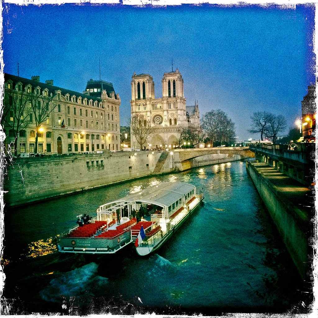 Bateau on the River Seine with Notre Dame in the background.