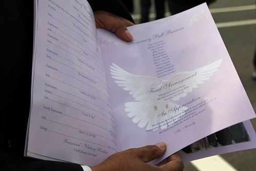 Whitney Houston funeral guest showing program to journalists | by Explorations Media, LLC