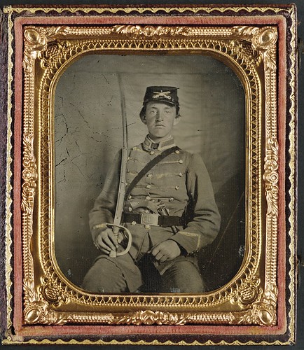 [Private David M. Thatcher of Company B, Berkeley Troop, 1st Virginia Cavalry Regiment, in uniform and Virginia sword belt plate with Adams revolver and cavalry sword] (LOC) | by The Library of Congress