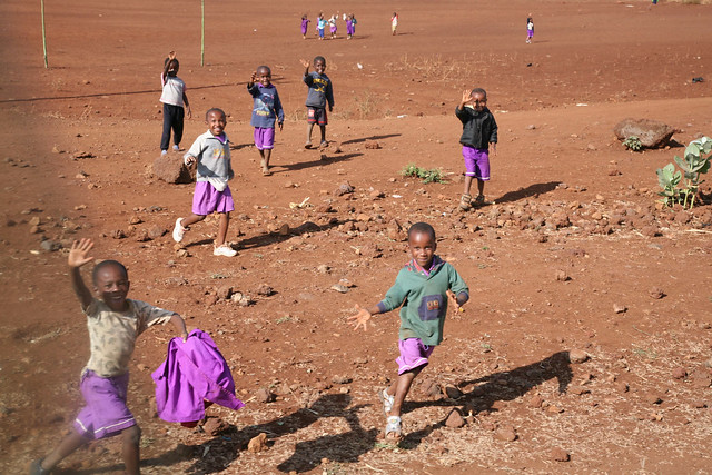 Laughing and Waving Tanzanian School Children Running to the Roadside Tanzania East Africa