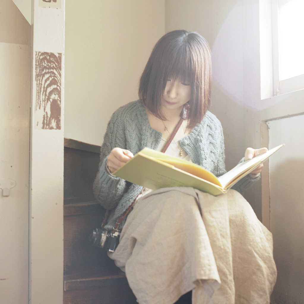 She was reading the old book in the old building.