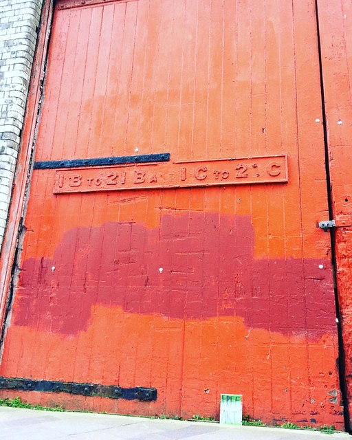 Find some art next to the biggest coolest red door in Salford. #illustrations #freeart #building #red #door #art #drawings