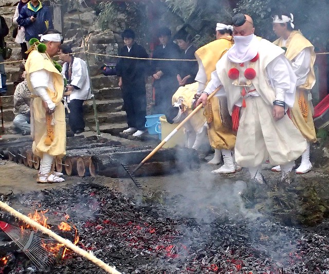 A Yamabushi (Japanese Mountain Ascetic Priest) prepares hot coals for firewalking