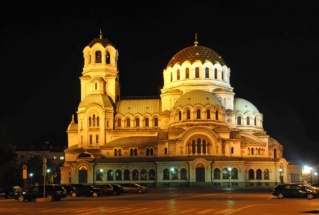 Bulgaria-0508 - St. Alexander Nevsky Cathedral: A large Cathedral in Byzantine style. There are two prominent domes, fashions with arched windows that go all the way around. Further, the photo is taken in the nighttime. 