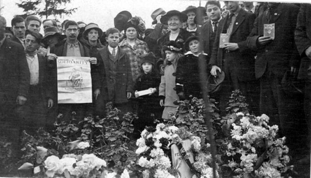 Funeral attendees holding IWW books and posters, November 18, 1916.