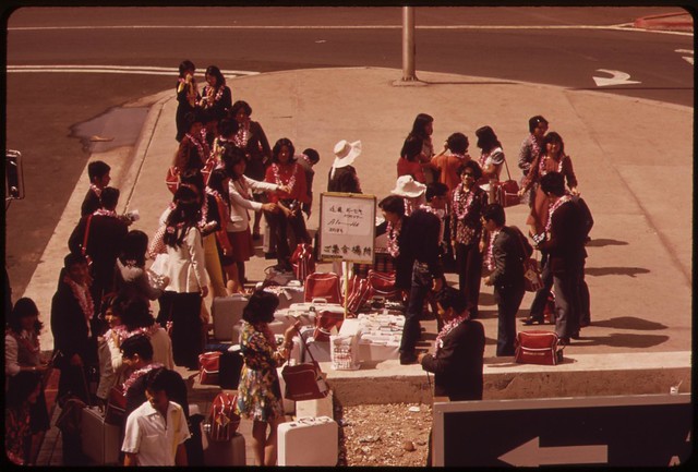 Honolulu International Airport handles almost all of the island's visitors. Some 2.7 million are anticipated in 1973. Welcomed with leis tourists now wait for bus to their hotel, October 1973