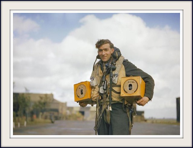Canadian PO (A) S Jess, wireless operator of an Avro Lancaster bomber operating from Waddington, Lincolnshire carrying two pigeon boxes. Homing pigeons served as a means of communications in the event of a crash, ditching or radio failure.