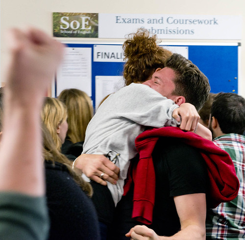English students hugging after receiving their results