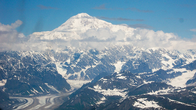Denali Park, AK: Mt McKinley at 20,320 Ft viewed from a 4-passenger Cessna flying at about 10,000 Ft. Denali is the highest elevation in North America. It is a granitic pluton of volcanic rock resulting from plate tectonics.