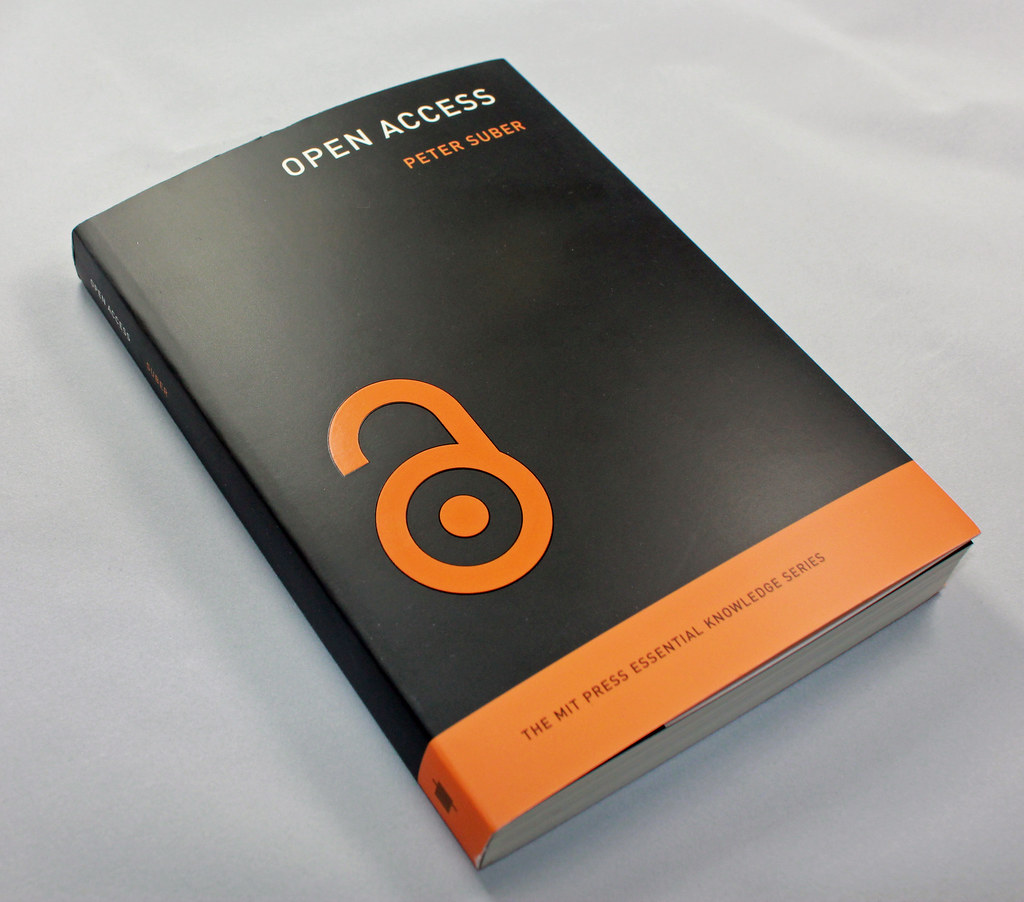 The book Open Access by Peter Suber, a book with a black cover with gold or orange accents with a large unlocked or open lock graphic