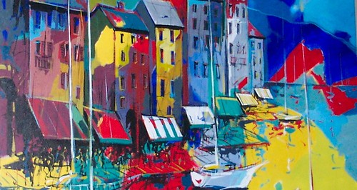 Tall colourful buildings beside a bright harbour
